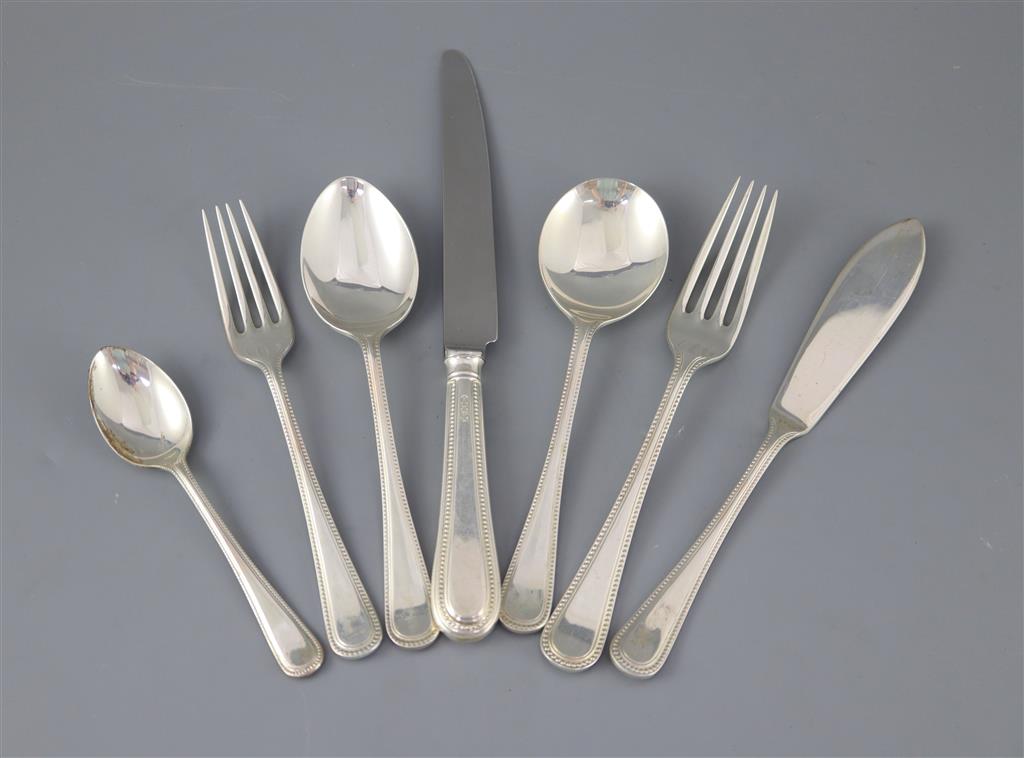 A modern part canteen of silver beaded Old English pattern flatware and cutlery, in mahogany case,